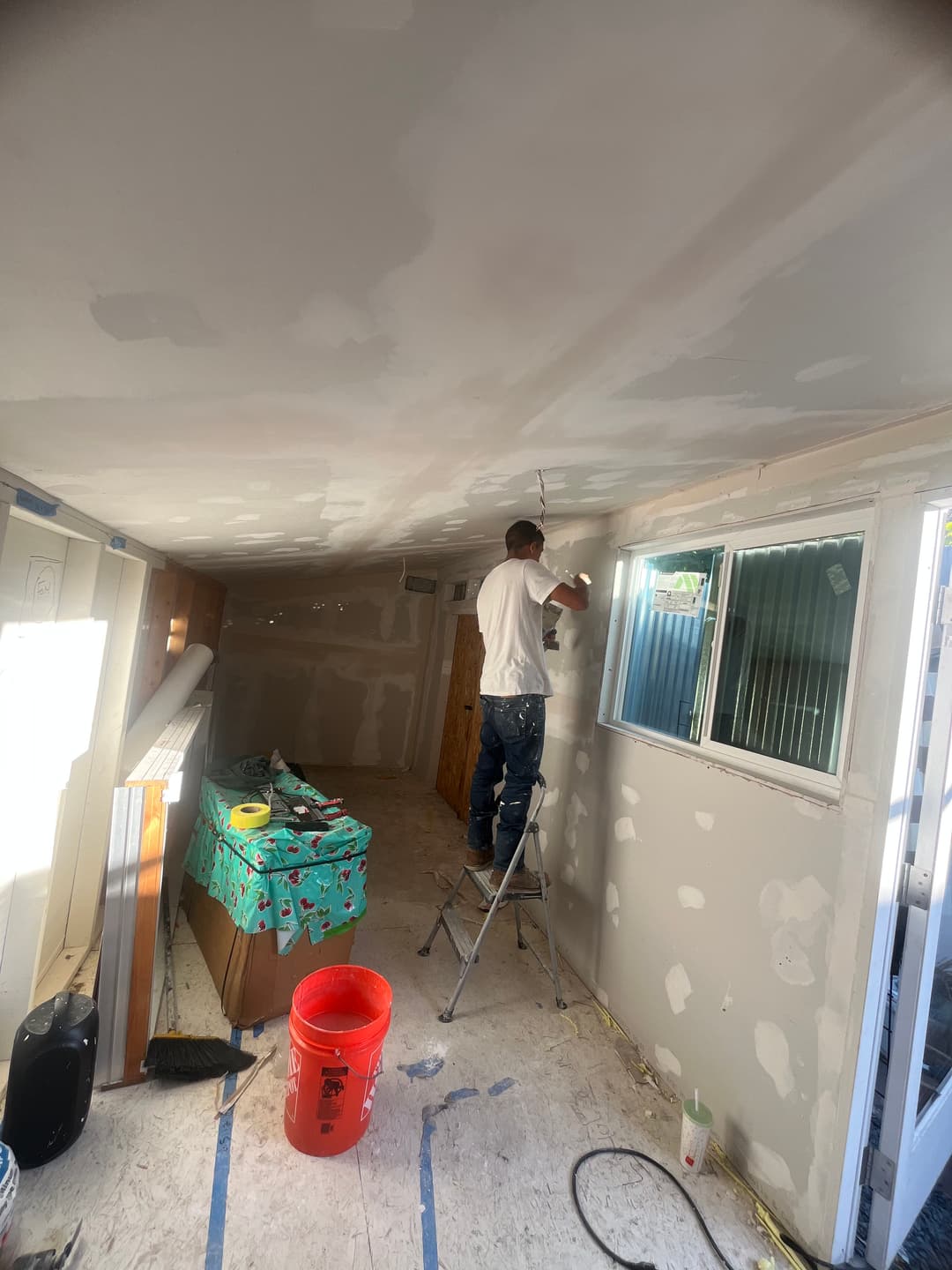 Interior renovation project with wall removal and construction cleanup