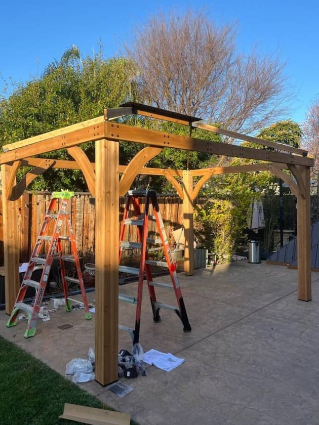 Pergola construction project with wood framing and outdoor structure setup