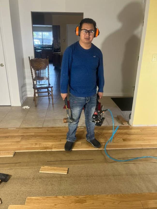 Local flooring contractor on job site preparing for residential flooring installation